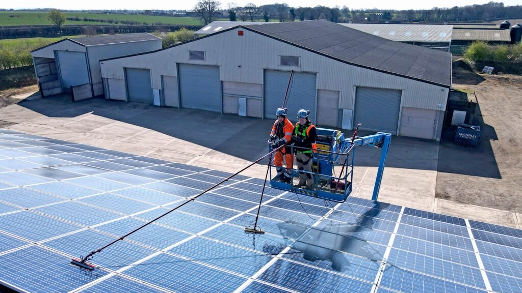 Commercial solar panel cleaning with boom truck large array